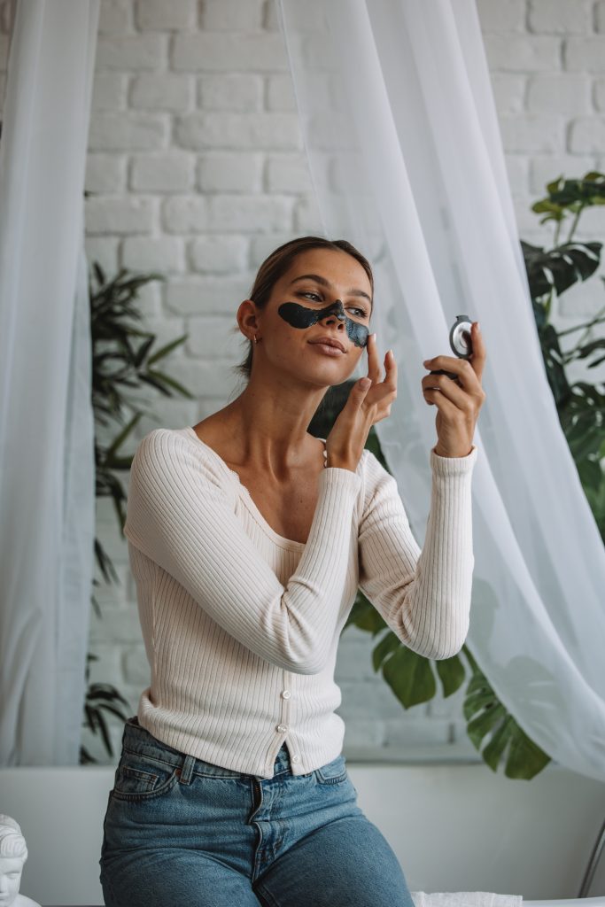 Woman Putting on Cleansing Face Mask