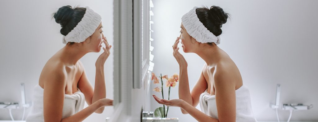 Woman applying skincare cream