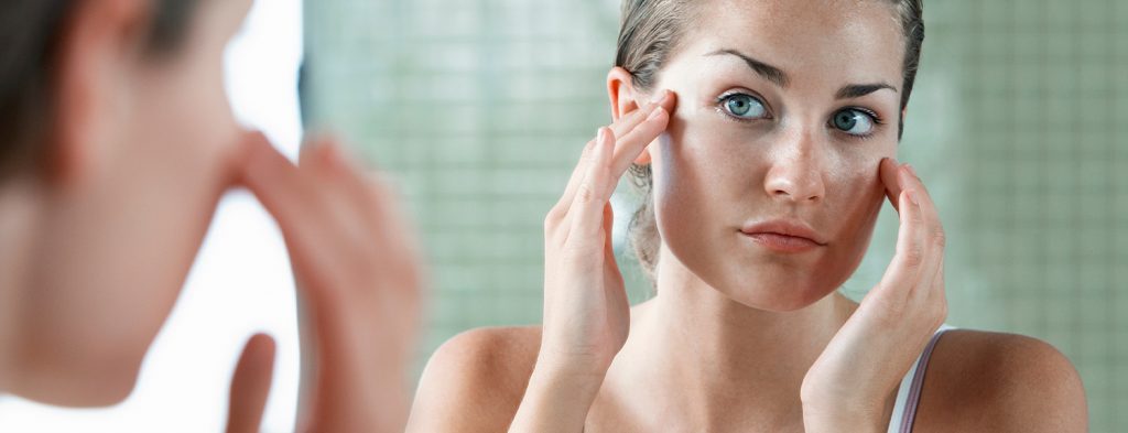 Woman examining face